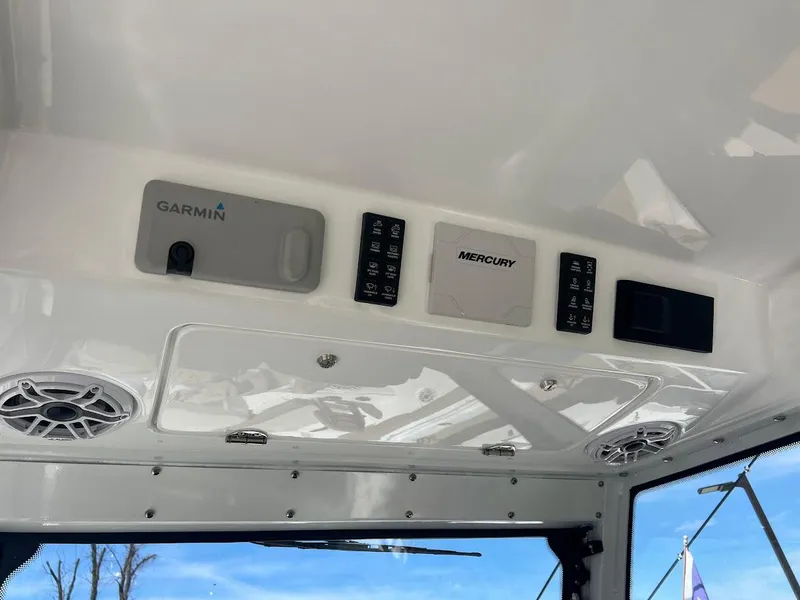 Slide: The Image of Control panel of 2024 Everglades 315 Center Console boat with Garmin and Mercury systems. - 23