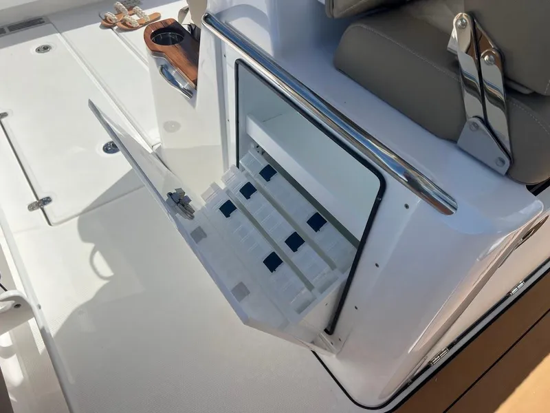 Slide: The Image of 2024 Everglades 315 Center Console boat with open storage compartment. - 26