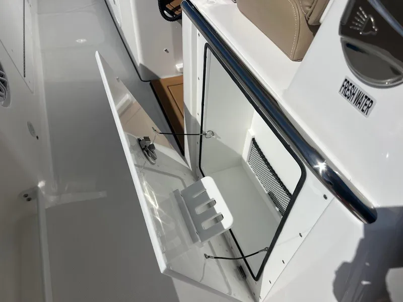 Slide: The Image of 2024 Everglades 315 Center Console boat with open storage compartment. - 29