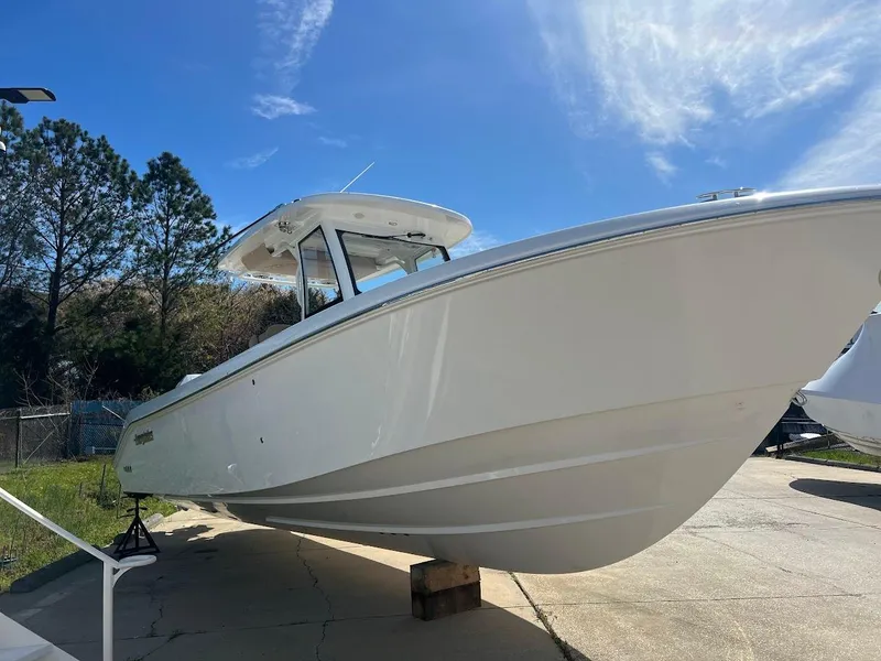 Slide: The Image of 2024 Everglades 315 Center Console boat on display under a clear blue sky. - 3
