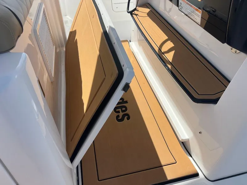 Slide: The Image of 2024 Everglades 315 Center Console boat interior with open storage compartments. - 30