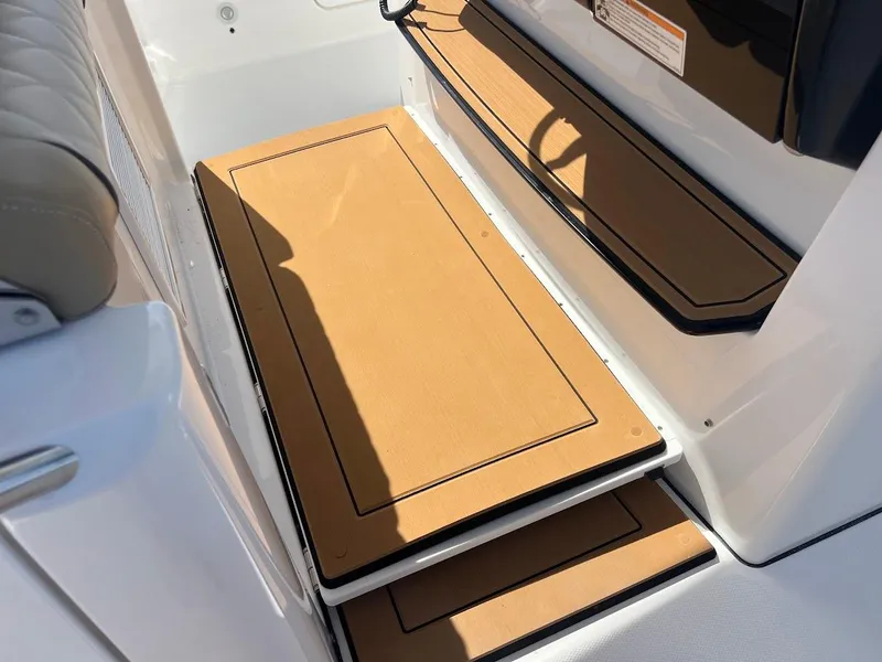 Slide: The Image of 2024 Everglades 315 Center Console boat interior steps with tan non-slip mats. - 31