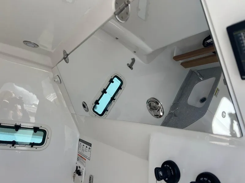 Slide: The Image of 2024 Everglades 315 Center Console interior cabin with windows and sink. - 34