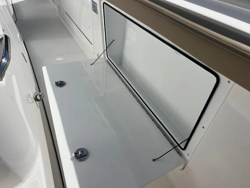 Slide: The Image of 2024 Everglades 315 Center Console storage compartment with open hatch. - 42