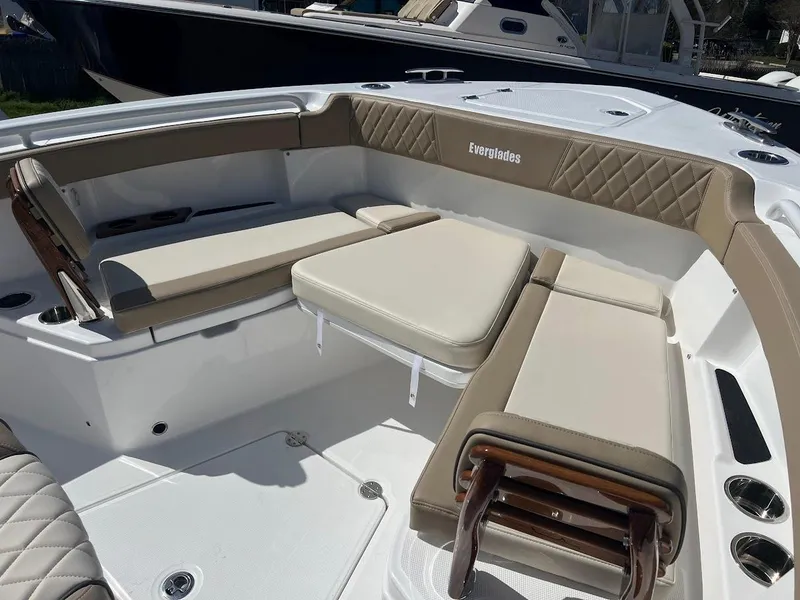 Slide: The Image of 2024 Everglades 315 Center Console boat with beige seating and white deck. - 43