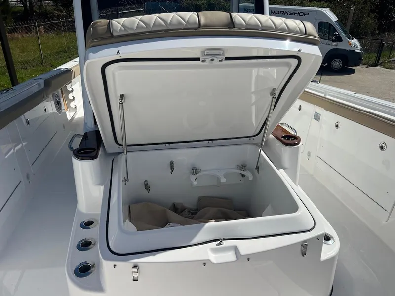 Slide: The Image of 2024 Everglades 315 Center Console boat with open storage compartment. - 46