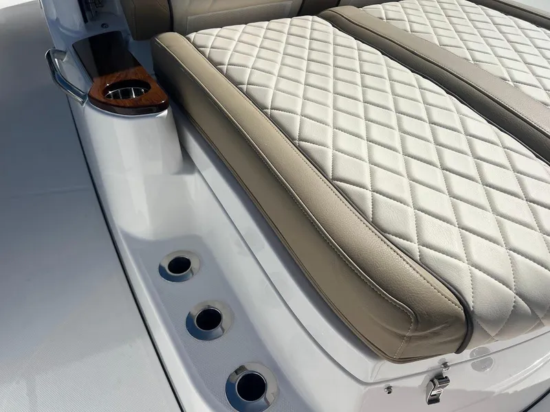 Slide: The Image of 2024 Everglades 315 Center Console boat with diamond-stitched seating and cup holder. - 49