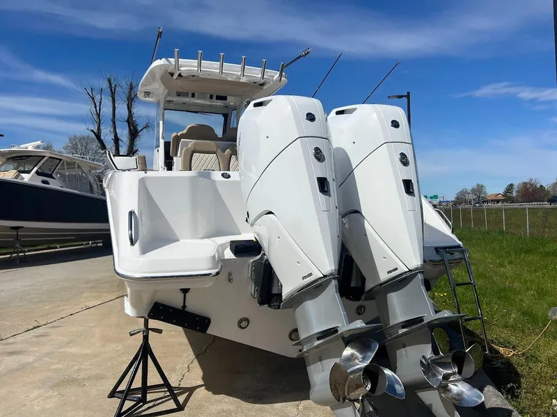 Slide: The Image of 2024 Everglades 315 Center Console boat with twin outboard engines. - 5