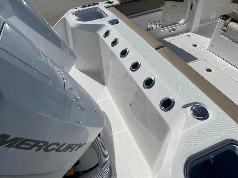 Slide: The Image of 2024 Everglades 315 Center Console boat with Mercury engines and rod holders. - 7