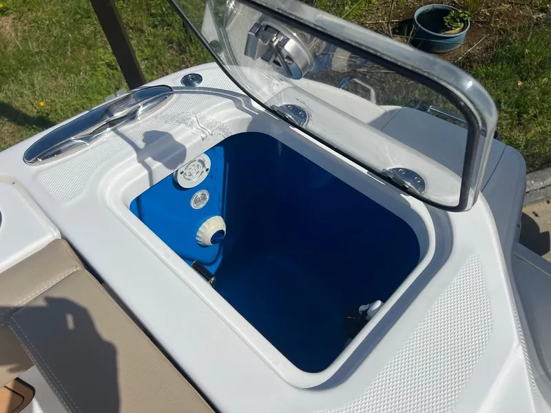 Slide: The Image of 2024 Everglades 315 Center Console livewell with open lid and blue interior. - 9