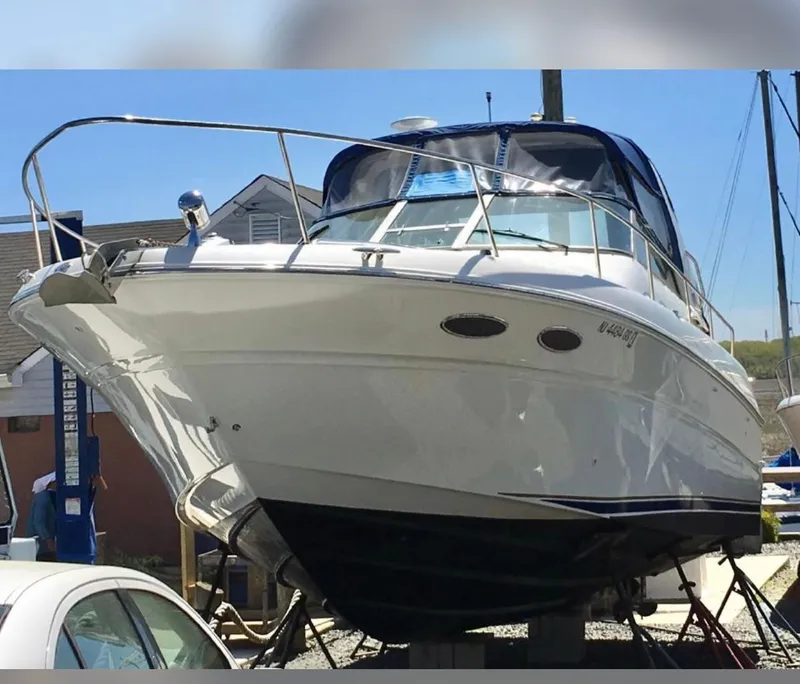 Slide: The Image of 2002 Sea Ray 310 Sundancer boat on dry dock. - 12