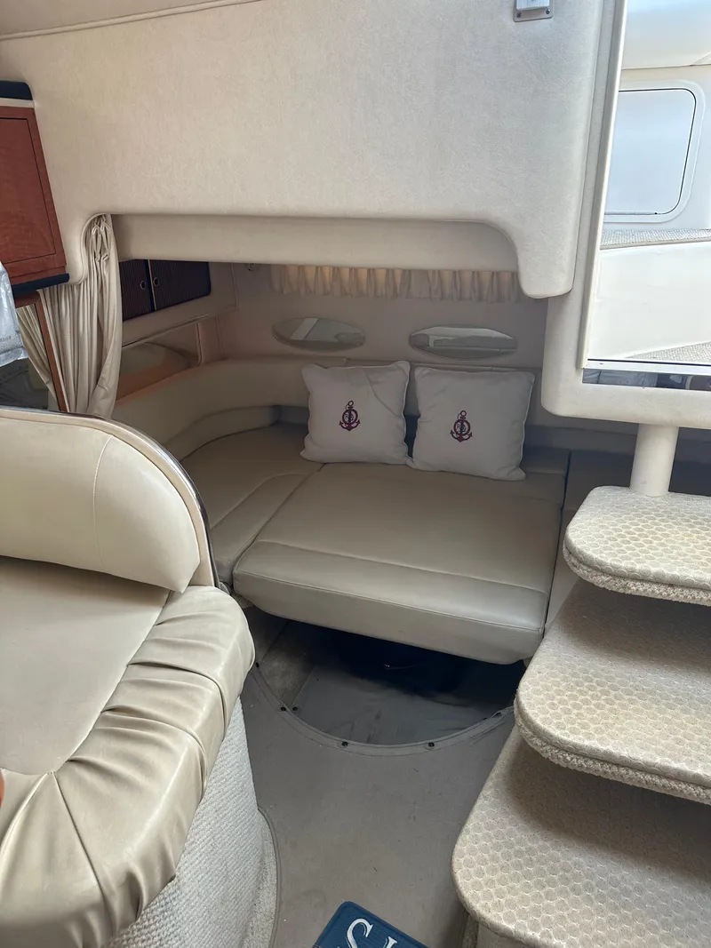 Slide: The Image of Interior of 2002 Sea Ray 310 Sundancer with beige seating and steps. - 17