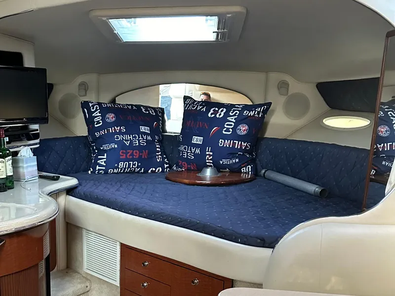 Slide: The Image of Interior of 2002 Sea Ray 310 Sundancer with cozy seating and nautical decor. - 27