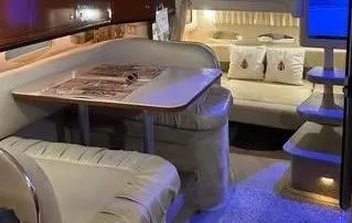 Slide: The Image of Interior of 2002 Sea Ray 310 Sundancer yacht with cozy seating and ambient lighting. - 28