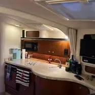 Slide: The Image of Interior of 2002 Sea Ray 310 Sundancer yacht kitchen with modern amenities. - 30
