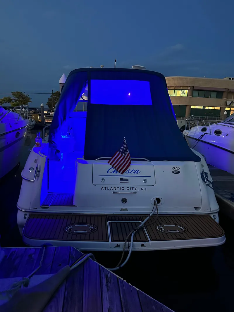 Slide: The Image of 2002 Sea Ray 310 Sundancer docked at night with blue lighting, Atlantic City, NJ. - 34