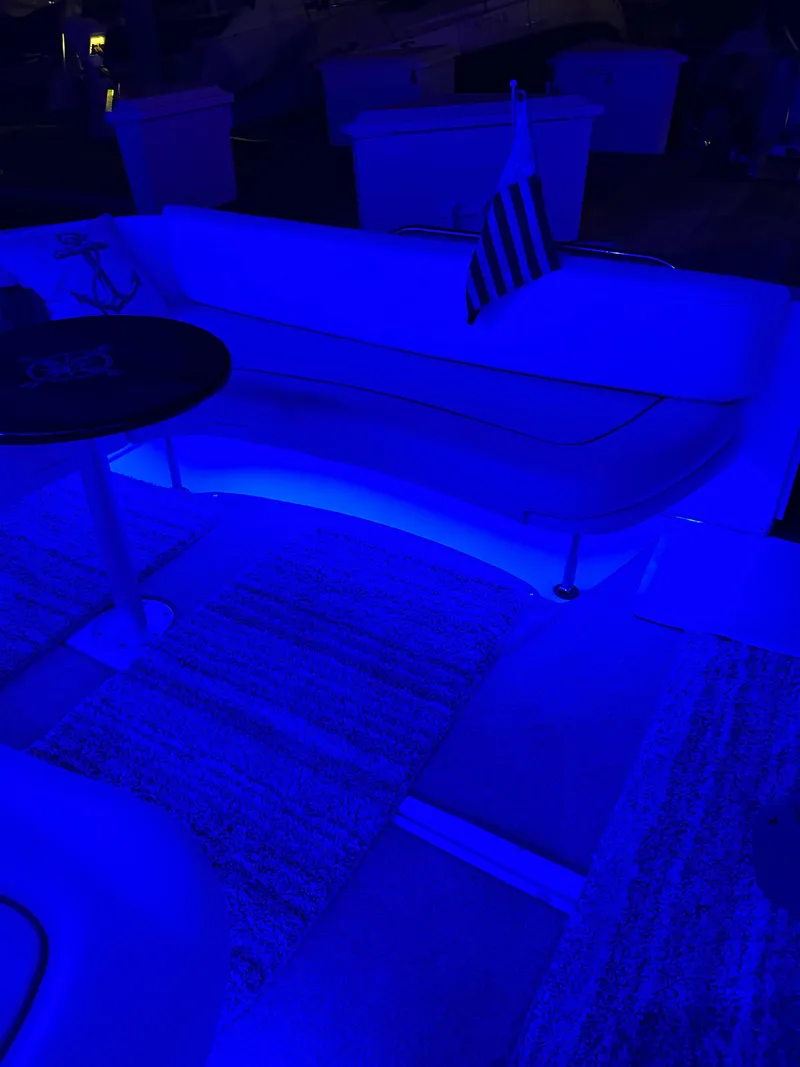 Slide: The Image of 2002 Sea Ray 310 Sundancer interior with blue lighting and American flag. - 36
