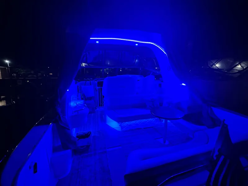 Slide: The Image of 2002 Sea Ray 310 Sundancer yacht interior illuminated with blue LED lights at night. - 39
