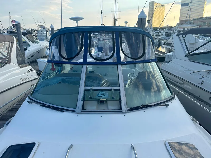 Slide: The Image of 2002 Sea Ray 310 Sundancer docked at marina, surrounded by other boats. - 44