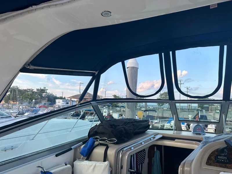 Slide: The Image of Interior view of 2002 Sea Ray 310 Sundancer boat with marina background. - 47