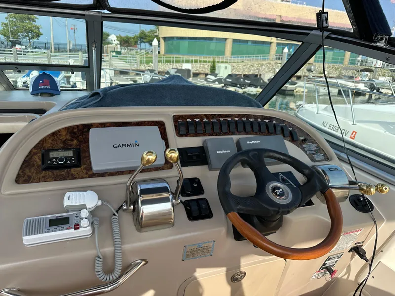 Slide: The Image of 2002 Sea Ray 310 Sundancer helm with Garmin navigation and control panel. - 6