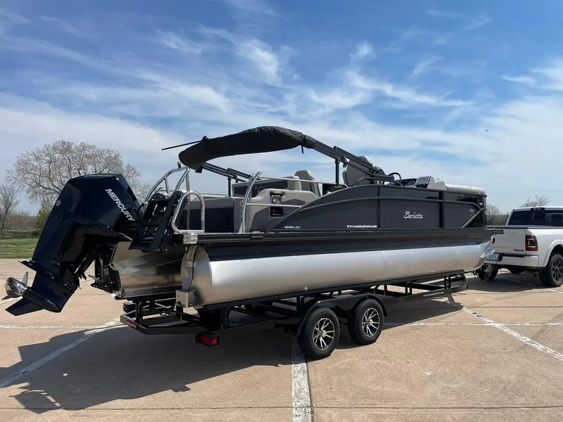 Slide: The Image of 2024 Barletta Cabrio 22UC pontoon boat on a trailer in a parking lot. - 11