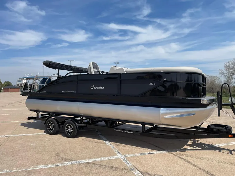 Slide: The Image of 2024 Barletta Cabrio 22UC pontoon boat on trailer in parking lot. - 13