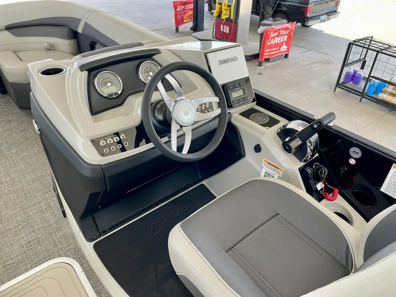 Slide: The Image of 2024 Barletta Cabrio 22UC boat dashboard and steering wheel at a dealership. - 25