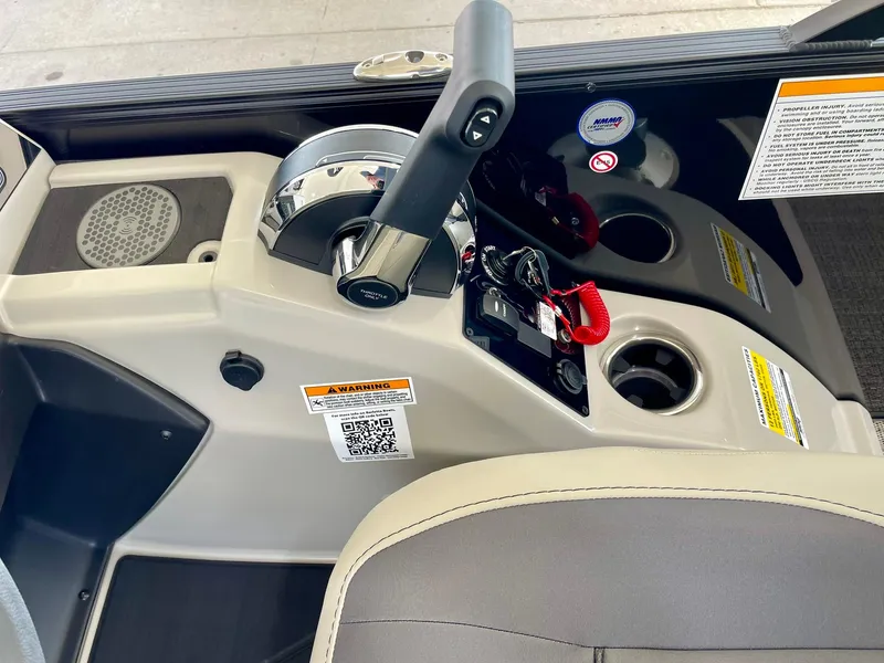 Slide: The Image of 2024 Barletta Cabrio 22UC boat control panel with throttle and cup holders. - 27