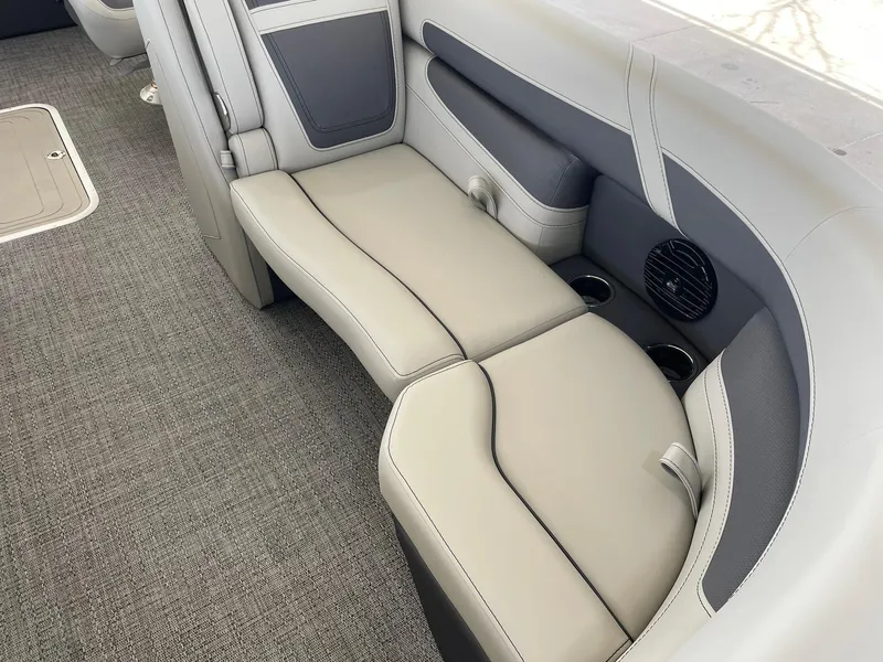 Slide: The Image of 2024 Barletta Cabrio 22UC boat interior seating with cup holders and speaker. - 34