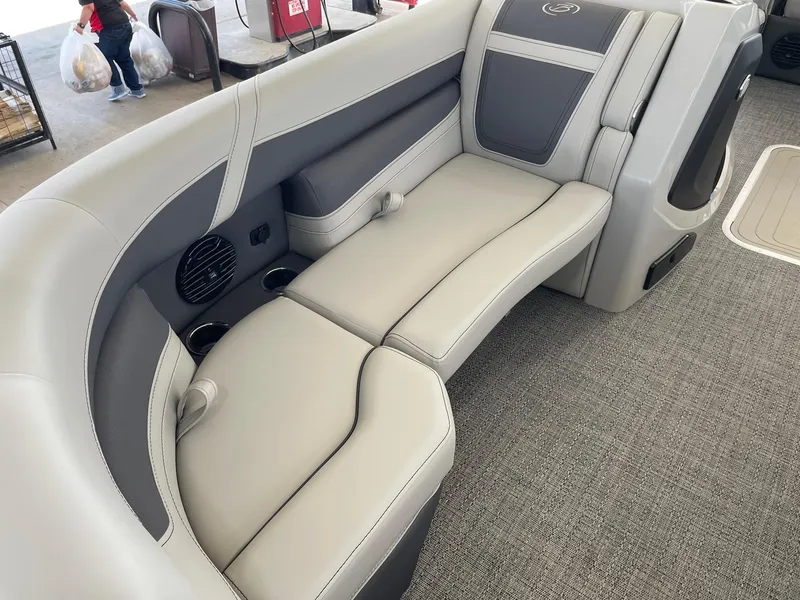 Slide: The Image of 2024 Barletta Cabrio 22UC boat interior with gray cushioned seating and cup holders. - 35