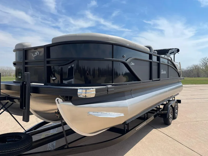 Slide: The Image of 2024 Barletta Cabrio 22UC pontoon boat on a trailer under a clear sky. - 4