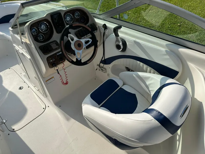 Slide: The Image of 2008 NauticStar 23DC boat cockpit with steering wheel and captain's chair. - 14