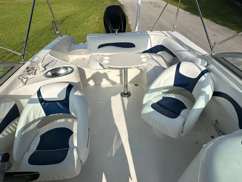 Slide: The Image of 2008 NauticStar 23DC boat interior with white and blue seating and a central table. - 21