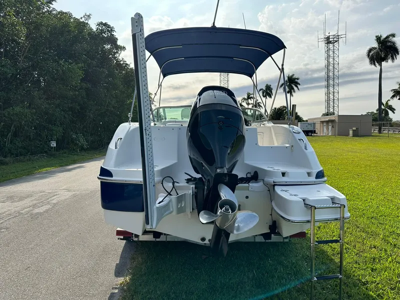 Slide: The Image of 2008 NauticStar 23DC boat with outboard motor and canopy, rear view. - 3