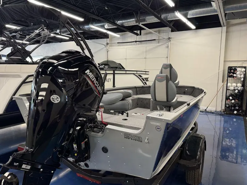 Slide: The Image of 2024 Alumacraft Voyageur 175 Tiller boat with Mercury outboard motor in showroom. - 3