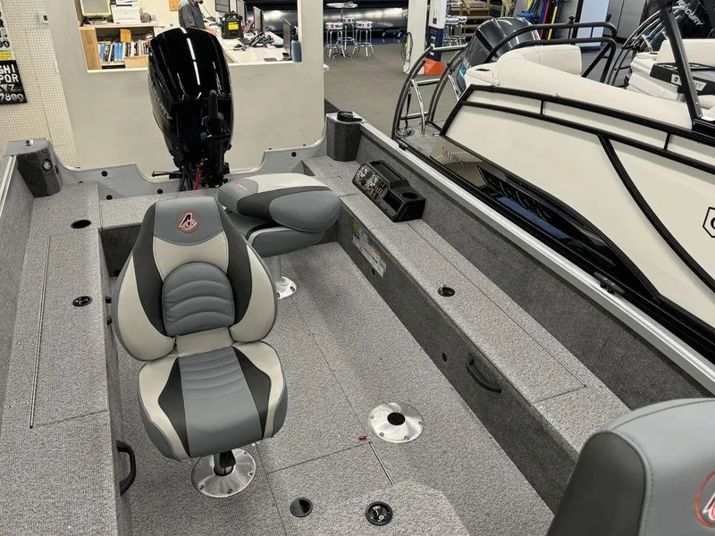 Slide: The Image of 2024 Alumacraft Voyageur 175 Tiller boat interior with seating and motor. - 4