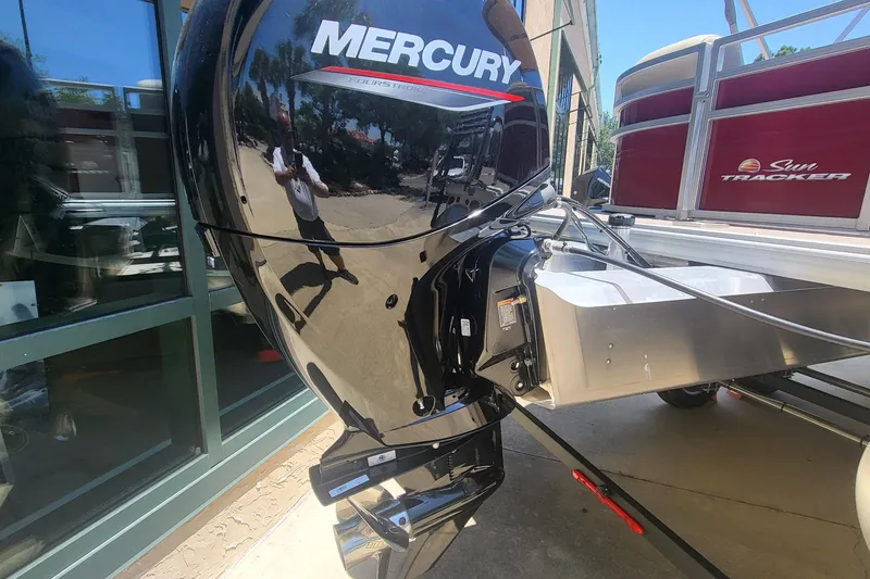 Slide: The Image of 2024 Sun Tracker Party Barge 24 DLX with powerful outboard motor. - 4