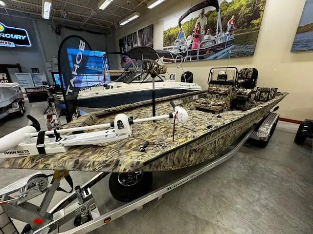 Slide: The Image of 2024 Ranger RB210 camo fishing boat on display in showroom. - 0