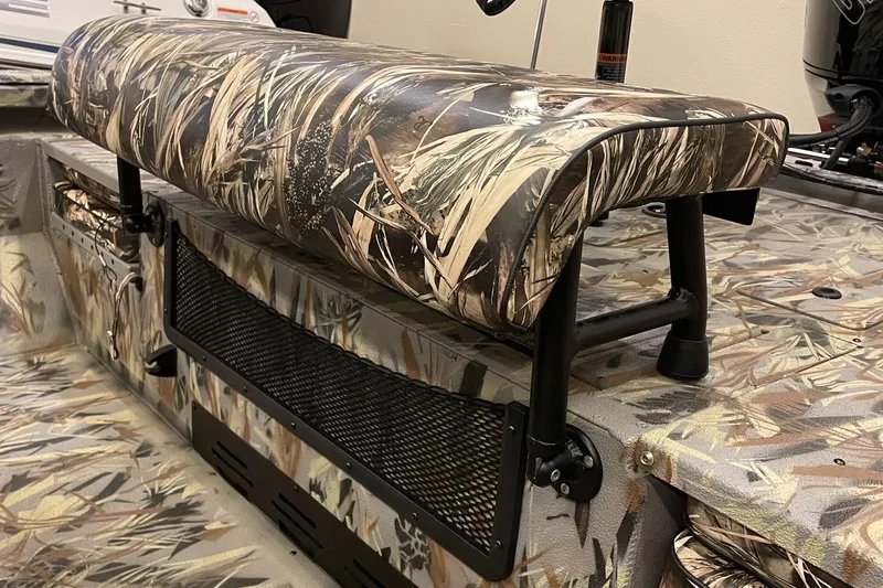 Slide: The Image of 2024 Ranger RB210 boat with camo seating and storage compartment. - 10