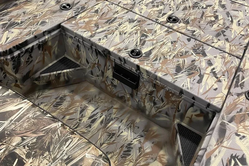 Slide: The Image of 2024 Ranger RB210 boat interior with camouflage design and storage compartments. - 13