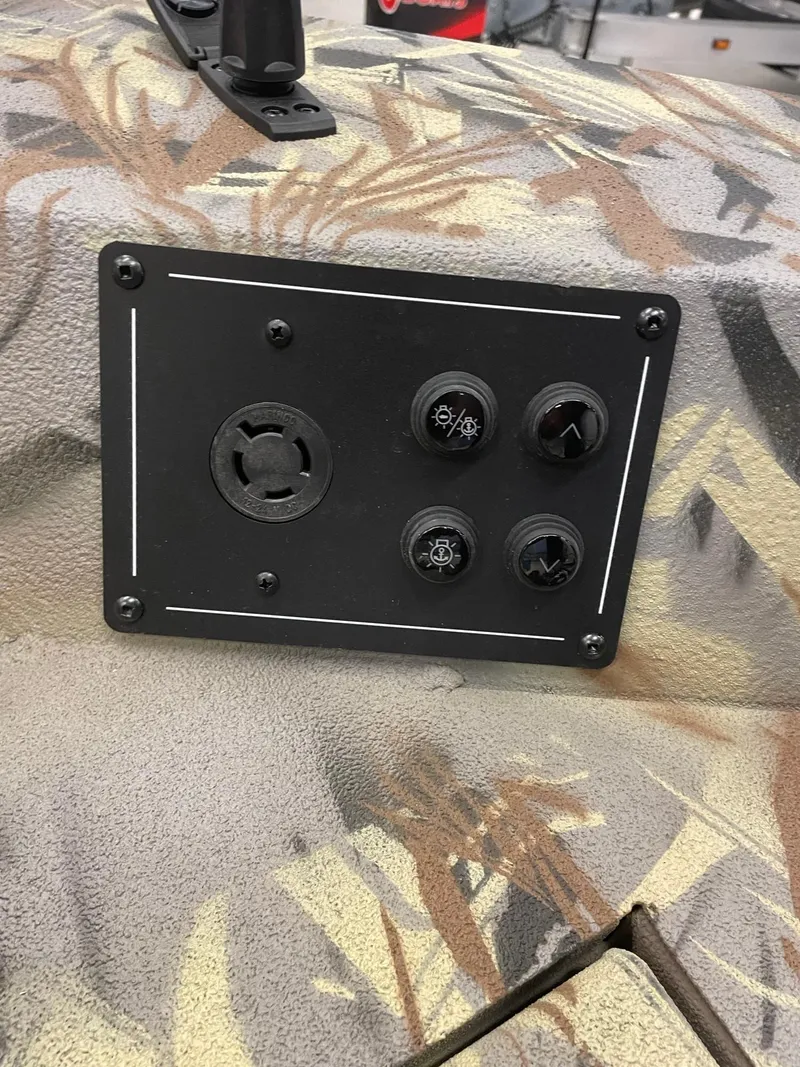 Slide: The Image of Control panel of a 2024 Ranger RB210 boat with camo design. - 8