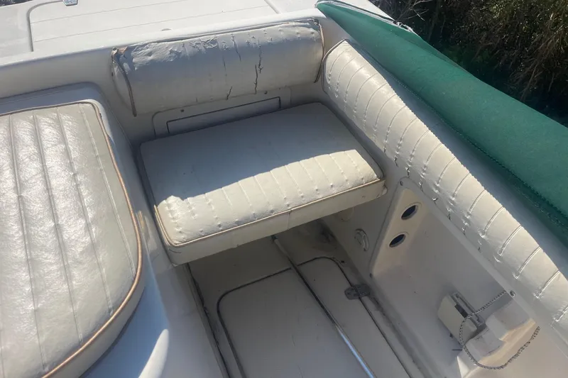 Slide: The Image of Worn seating area on a 2000 Seamaster 2388 WA boat with white upholstery. - 10