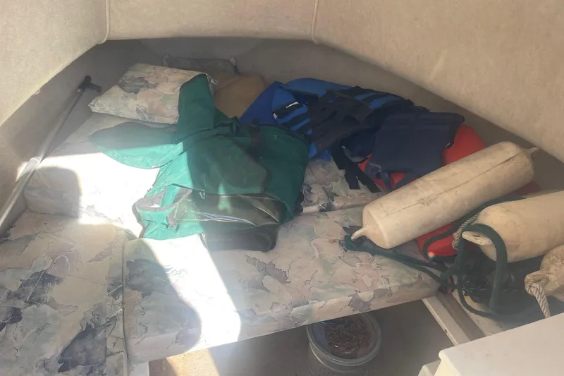 Slide: The Image of Interior of a 2000 Seamaster 2388 WA boat with life jackets and fenders. - 13