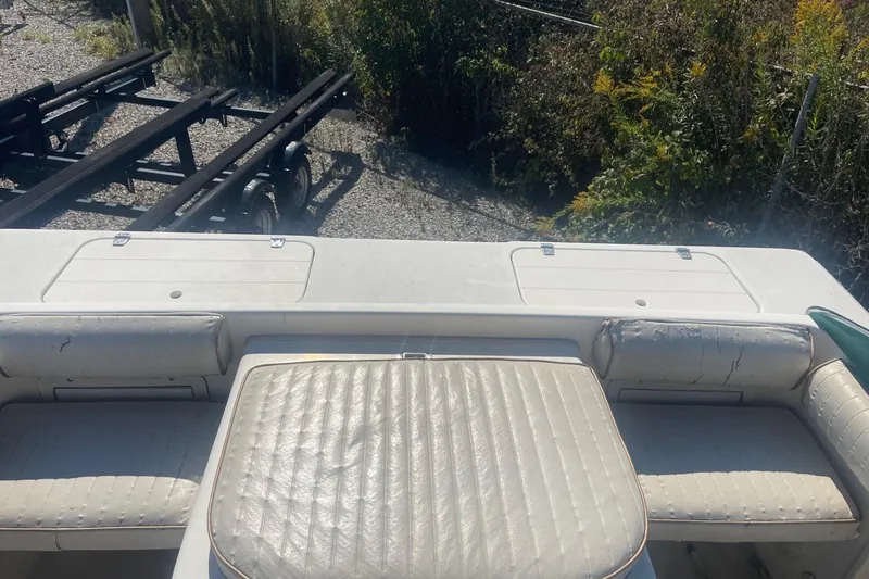 Slide: The Image of Rear view of a 2000 Seamaster 2388 WA boat with worn white seating. - 14