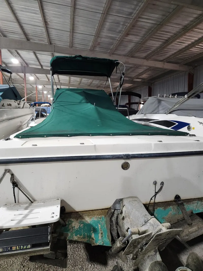Slide: The Image of 2000 Renken Seamaster 2288 WA boat with green cover in storage. - 2