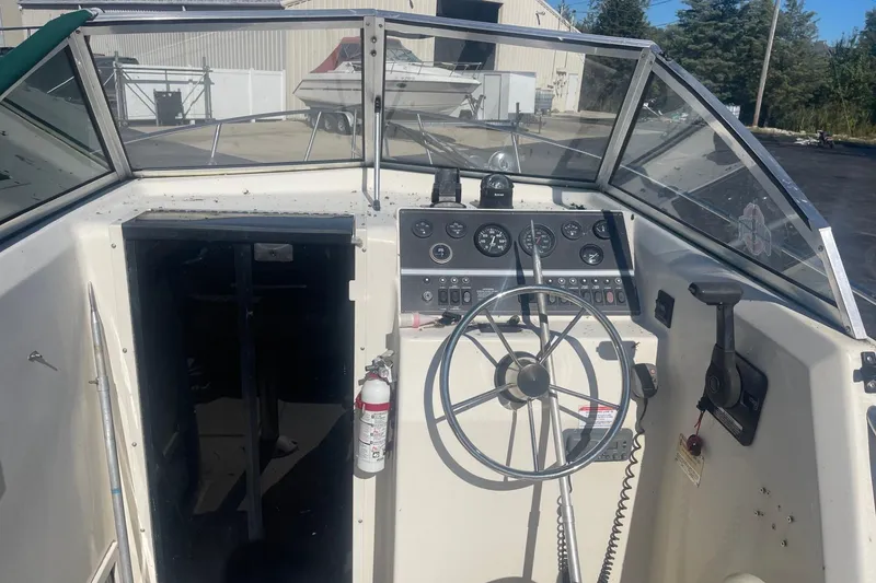 Slide: The Image of Cockpit of 2000 Seamaster 2388 WA boat with steering wheel and control panel. - 7