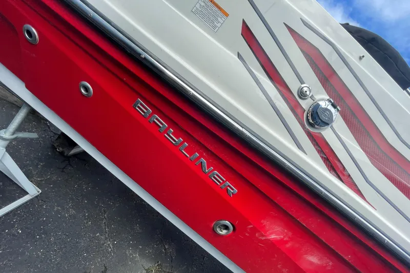 Slide: The Image of 2021 Bayliner VR5 boat, red and white exterior, close-up view. - 10