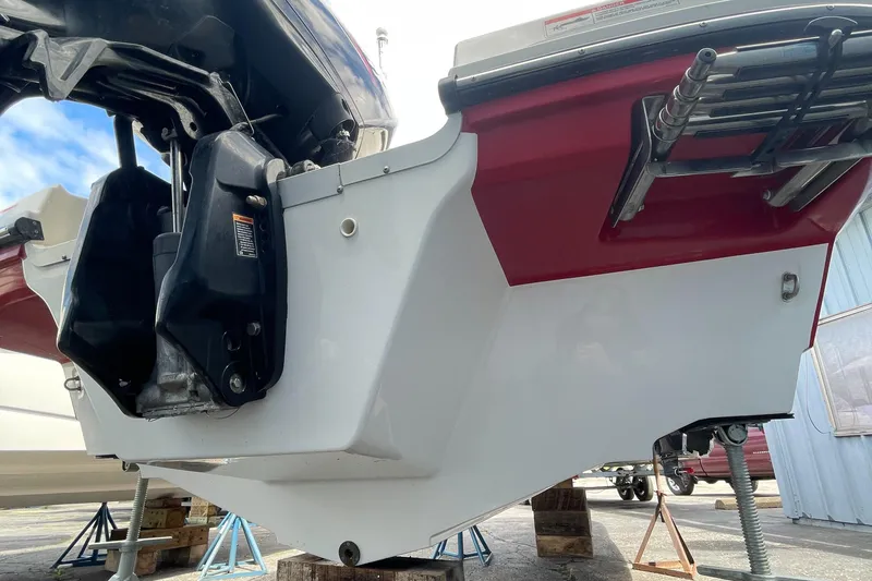 Slide: The Image of 2021 Bayliner VR5 boat stern view with outboard motor and swim ladder. - 8