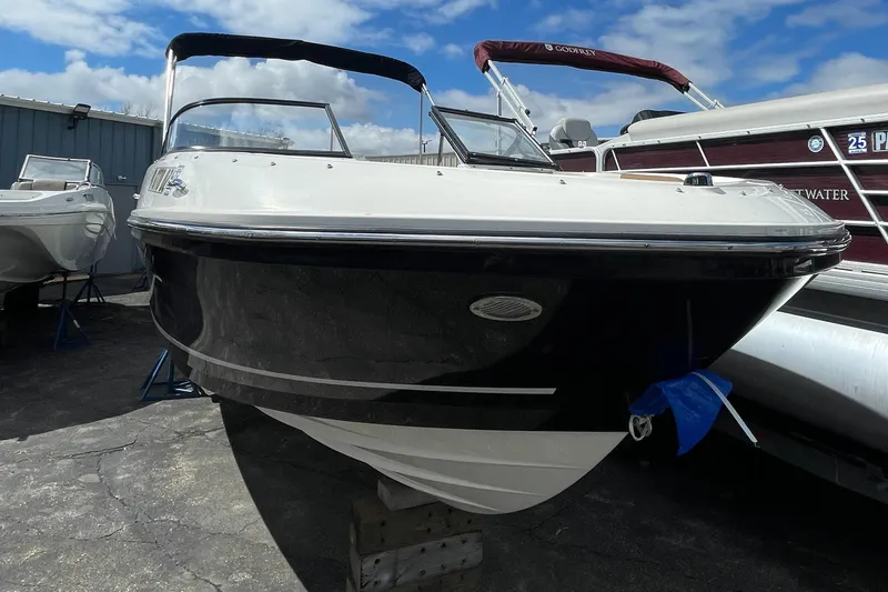 Slide: The Image of 2021 Bayliner VR5 boat on display at a marina. - 11